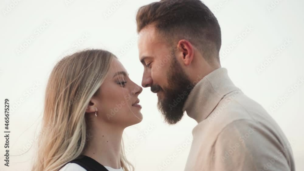 Lovely Couple Touching Noses While Gazing Into Each Other During Windy Weather. medium shot Lovely Couple Touching Noses While Gazing Into Each Other During Windy Weather. medium shot