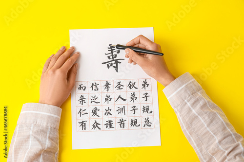 Asian calligraphist writing...