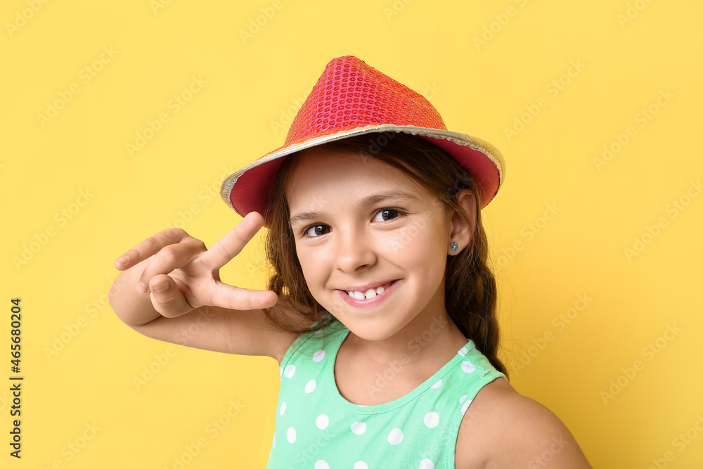 Cool stylish little girl showing victory gesture on color background Cool stylish little girl showing victory gesture on color background