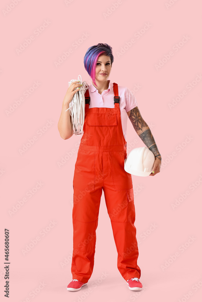 Female electrician with cables on color background Female electrician with cables on color background