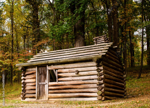 Soldiers' Hut, Jockey Hollow, Morristown National Historical Park, New Jersey, USA.  Replica of log cabin soldiers' huts used by Washington's Continental Army in the Revolutionary War. Autumn colors.