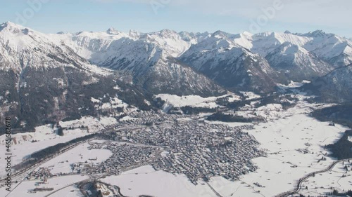 Aerial view overlooking the Oberstdorf village, in middle of snowy mountains, winter in Germany photo