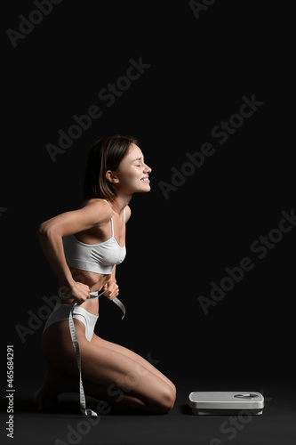 Young woman with scales and...