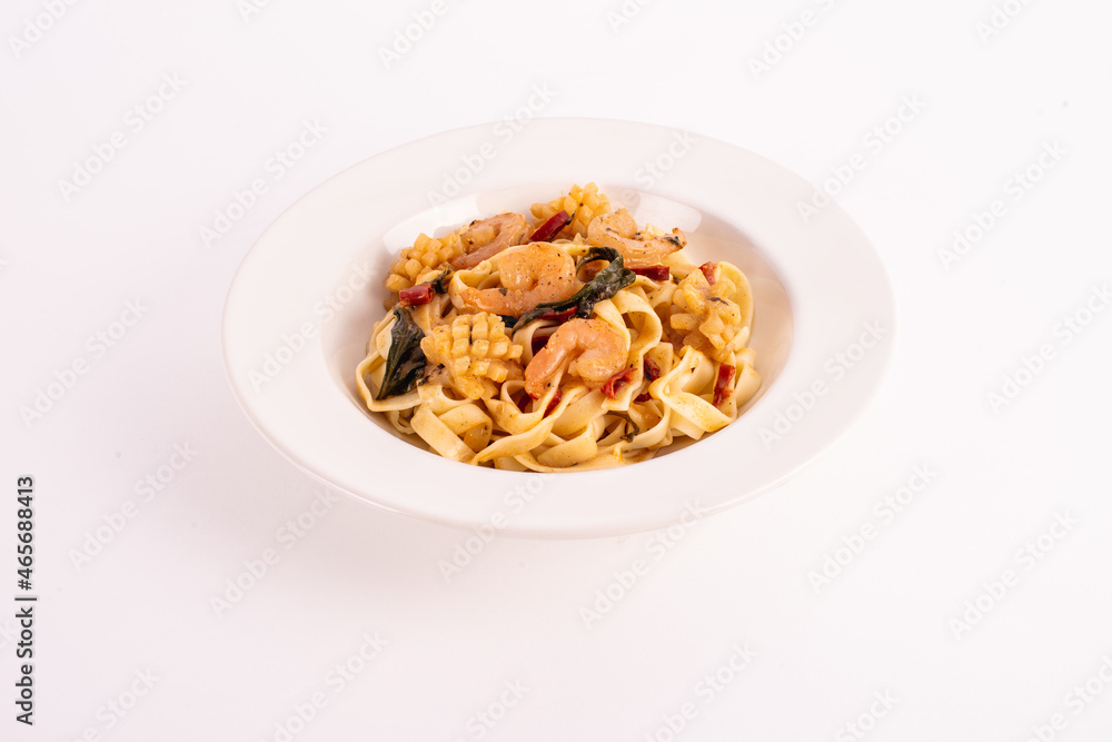 Contemporary Thai cuisine. Seafood spaghetti on white dish Contemporary Thai cuisine. Seafood spaghetti on white dish