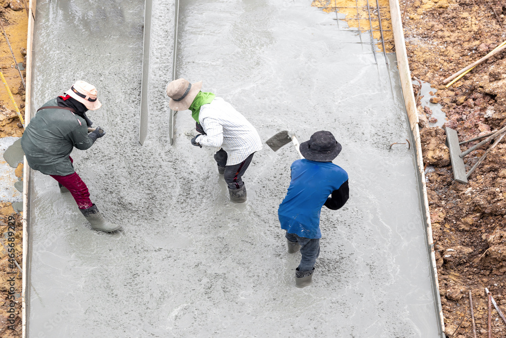 Professional workers make cement floors on construction sites Professional workers make cement floors on construction sites