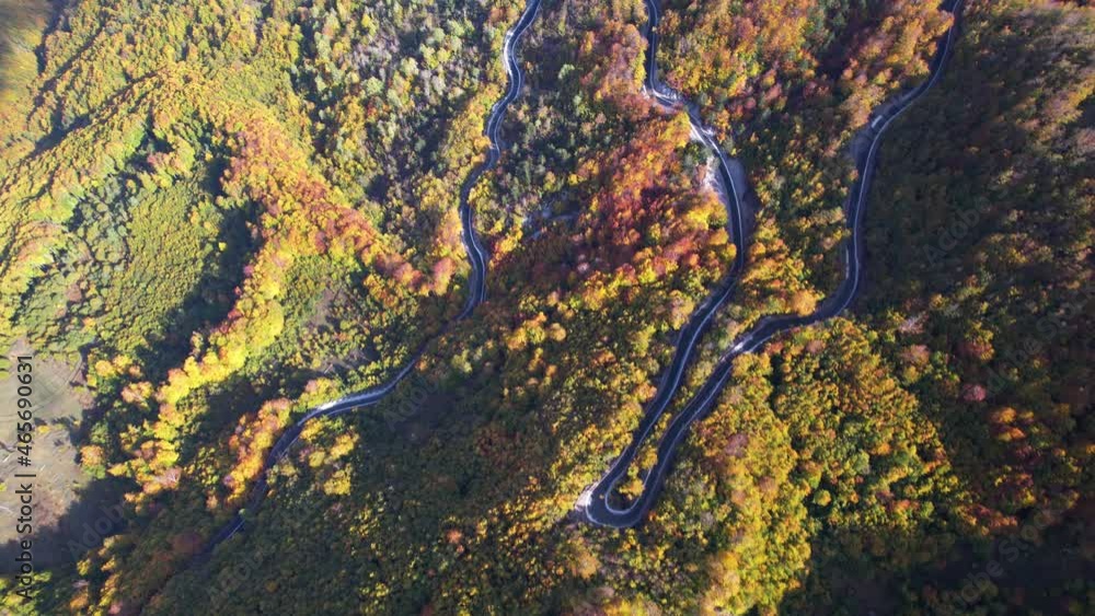 Winding road on mountain landscape with hills and colorful forest trees in Autumn Winding road on mountain landscape with hills and colorful forest trees in Autumn