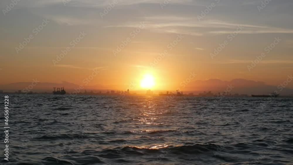 Sunrise with the silhouette of a city in the foreground. Sunrise with the silhouette of a city in the foreground.