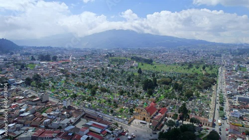 Drone aerial footage of urban colonial graveyard cemetery burial grounds churchyard Cementerio General in Central American highlands city Quetzaltenango, Xela, Guatemala on a bright sunny day. photo