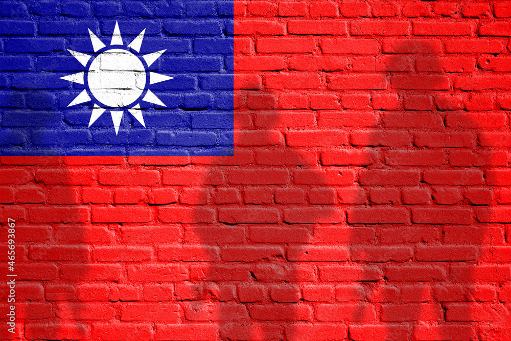 Flag of Taiwan painted on a brick wall with soldiers shadows