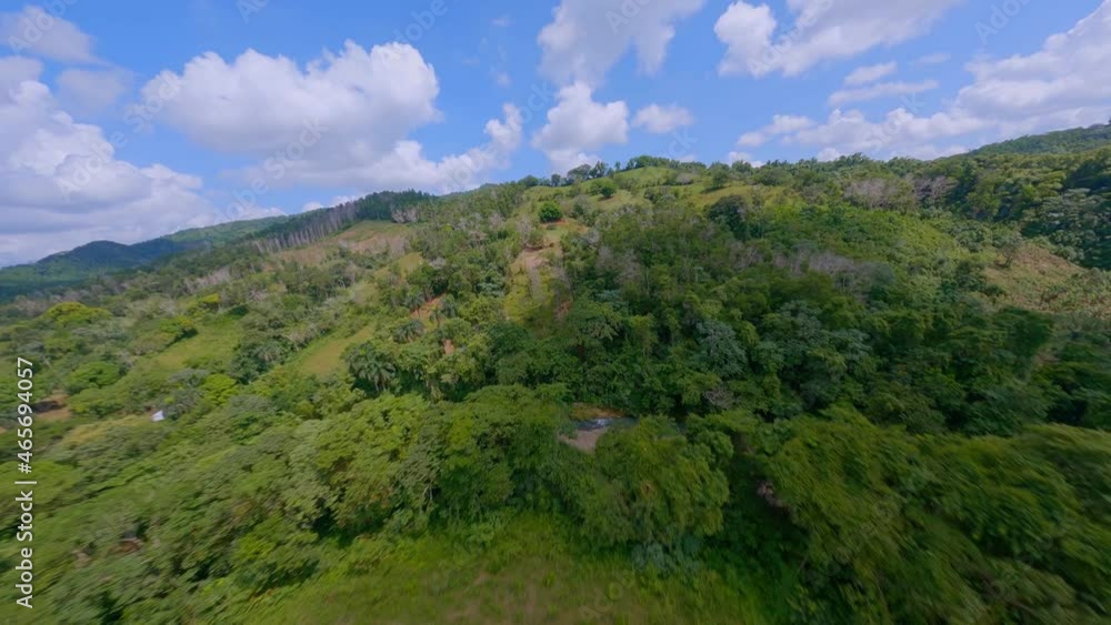 FPV On Rural Landscape With Dense Mountain Vegetation, Green Fields And Cloudy Blue Sky In La Cuaba, Dominican Republic FPV On Rural Landscape With Dense Mountain Vegetation, Green Fields And Cloudy Blue Sky In La Cuaba, Dominican Republic