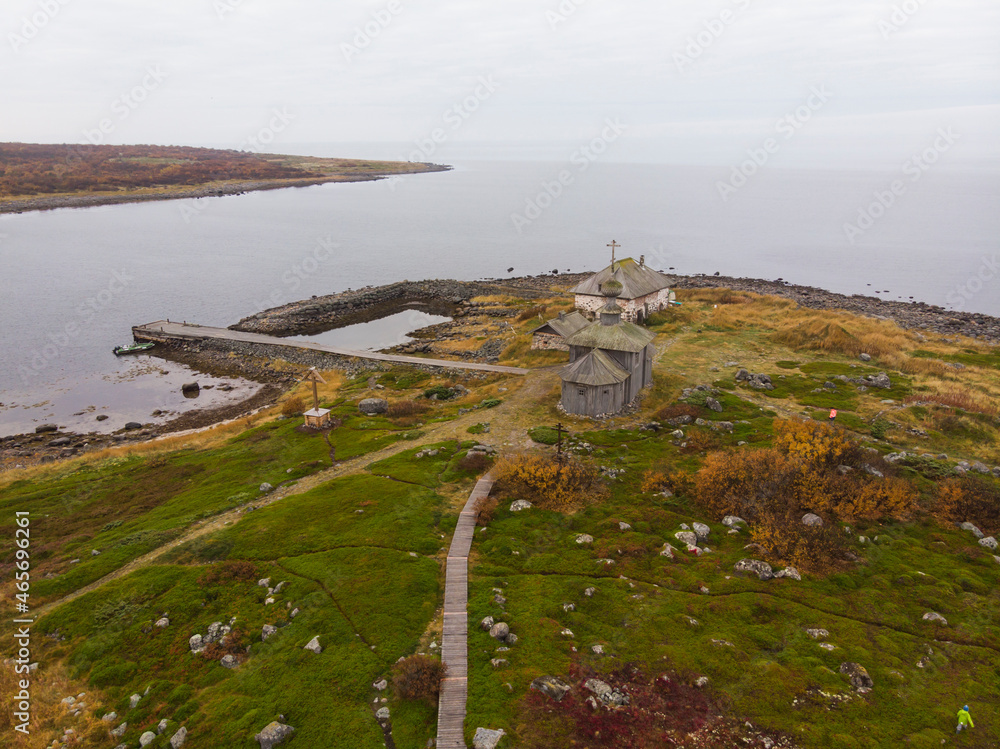 View of the hermitage of St. Andrew the First-Called on Solovki. Big Zayatsky Island. Stone harbor and wooden church 