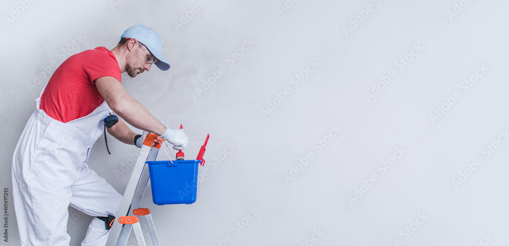 Interior Painter Contractor Worker on a Ladder Interior Painter Contractor Worker on a Ladder
