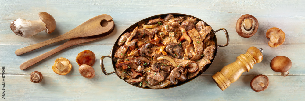 Beef stroganoff panorama. Mushroom and meat ragout with cream sauce, in a pan with ingredients, overhead flat lay shot on a rustic wooden background - obrazy, fototapety, plakaty 