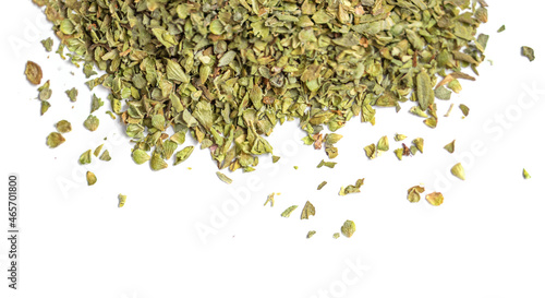 Dried oregano spice isolated on white background. Pile of dry oregano or marjoram leaves top view.