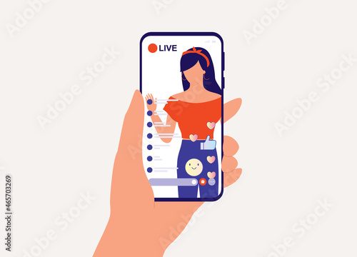 A Person With Mobile Phone Watching A Fashion Woman Influencer Doing Live Streaming While Getting Lots Of Positive Feedback And Responses From Her Followers. Social Media And Marketing. Vlogger.