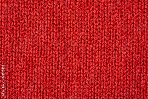 Red knitted wool texture background photo