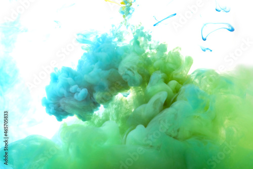 Ink in the water. A splash of green paint. Abstract background. selective focus.