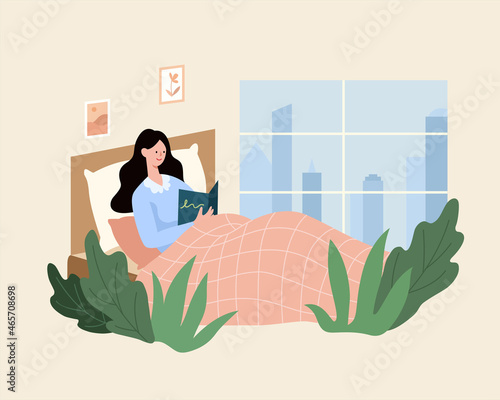Woman reading a book in bed