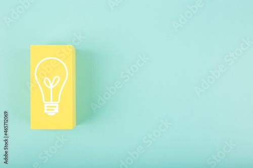 Creativity, innivation and idea concept. Light bulb drawn on yellow rectangle on bright blue background with copy space