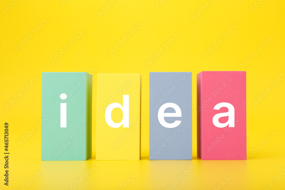 Creativity, innovation and idea concept. Single word idea written on multicolored rectangles on yellow background Creativity, innovation and idea concept. Single word idea written on multicolored rectangles on yellow background