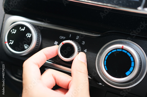 Person finger turn off the car air conditioner knob photo