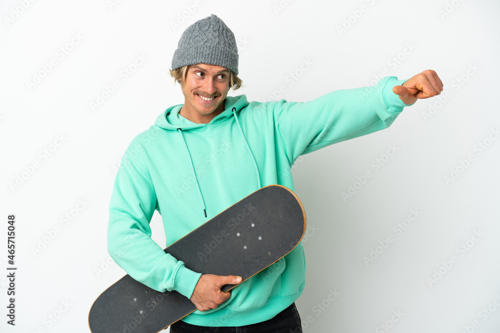Young skater blonde man isolated on white background giving a thumbs up gesture Young skater blonde man isolated on white background giving a thumbs up gesture