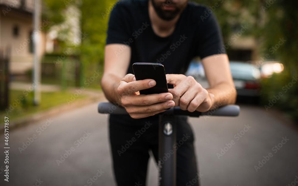 Fototapeta premium Close up of man hands holding a smart phone on the street