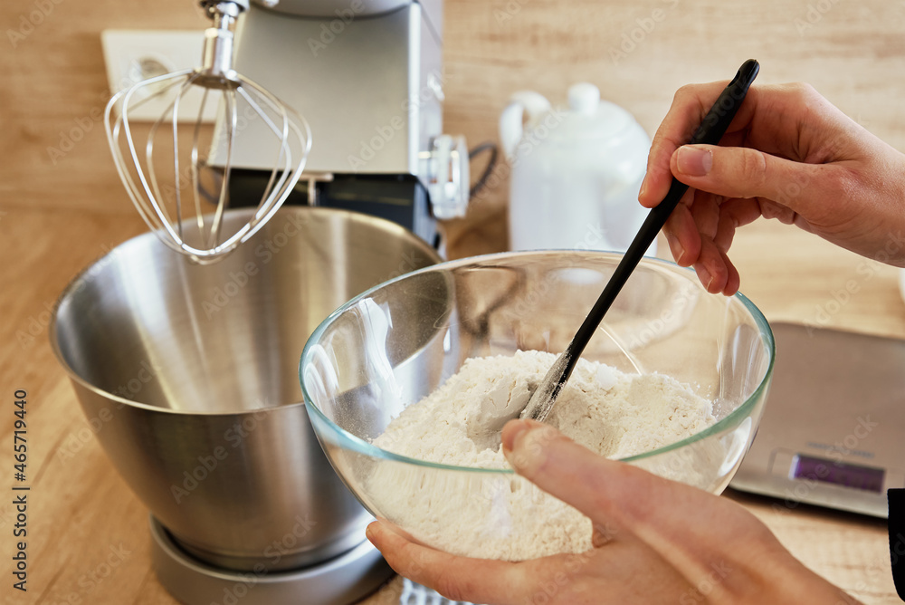 Woman mixed ingredients in kitchen mixer bowl. Homemade cooking Woman mixed ingredients in kitchen mixer bowl. Homemade cooking