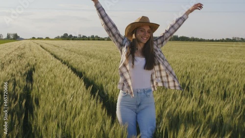 woman farmer walking through wheat field	