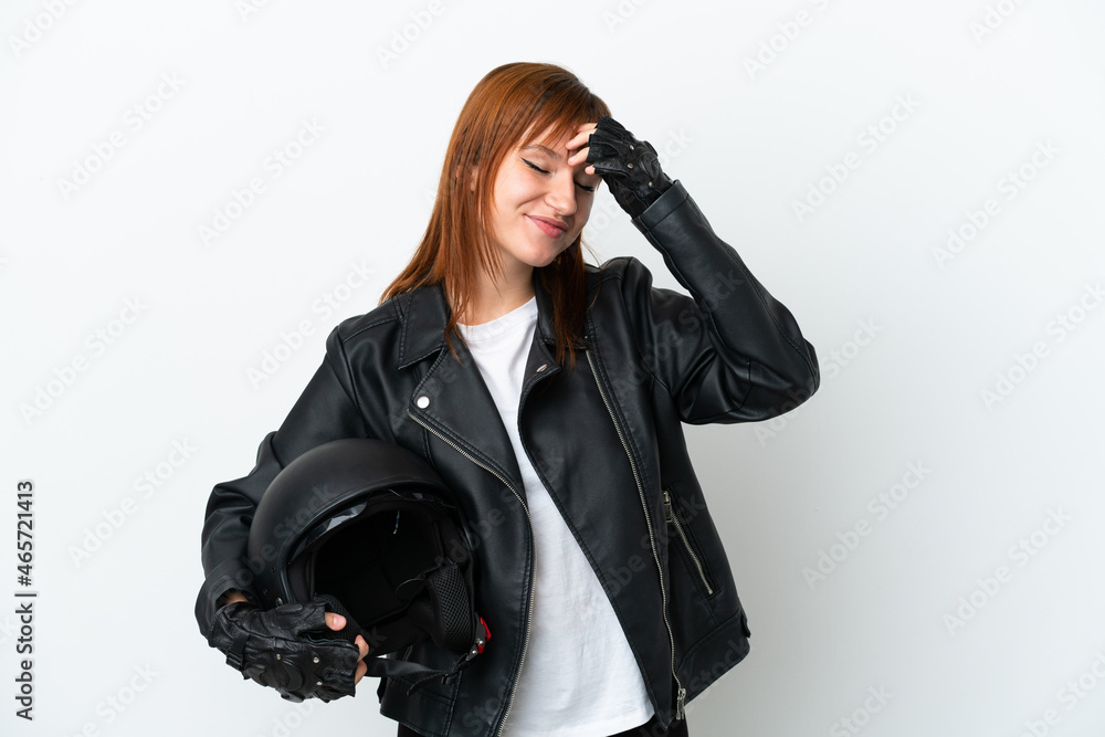 Redhead girl with a motorcycle helmet isolated on white background laughing Redhead girl with a motorcycle helmet isolated on white background laughing