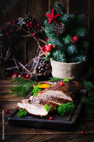 Baked pork belly with herbs. Boiled pork. Festive Christmas table.