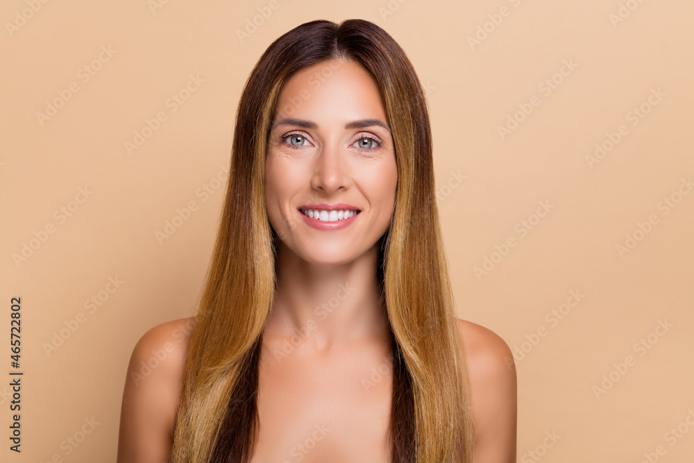 Portrait of attractive cheery long-haired woman with clear pure fresh skin lifting effect isolated over beige pastel color background Portrait of attractive cheery long-haired woman with clear pure fresh skin lifting effect isolated over beige pastel color background