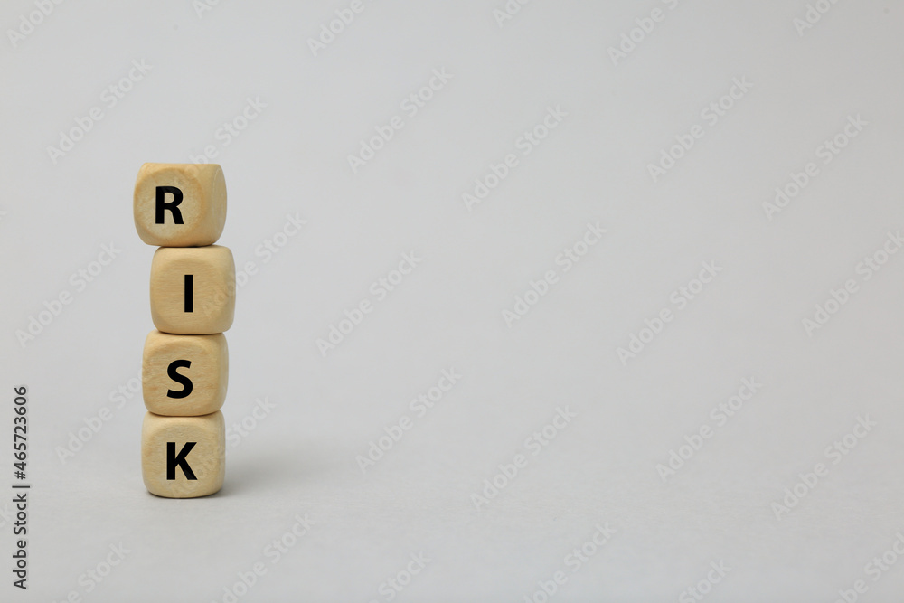 Stack of wooden cubes with word Risk on light grey background. Space for text Stack of wooden cubes with word Risk on light grey background. Space for text