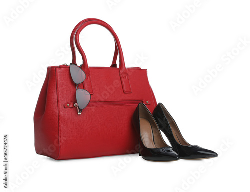 Stylish woman's bag, sunglasses and shoes isolated on white