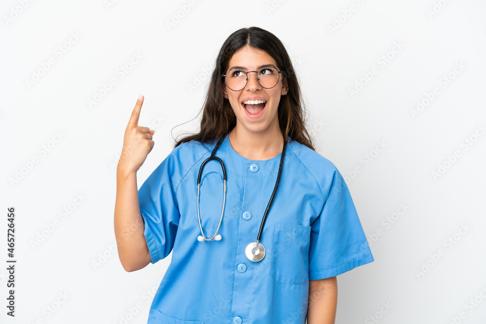 Young surgeon doctor caucasian woman isolated on white background pointing up and surprised Young surgeon doctor caucasian woman isolated on white background pointing up and surprised