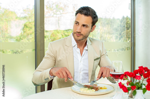 Attractive man having lunch in a hotel restaurant