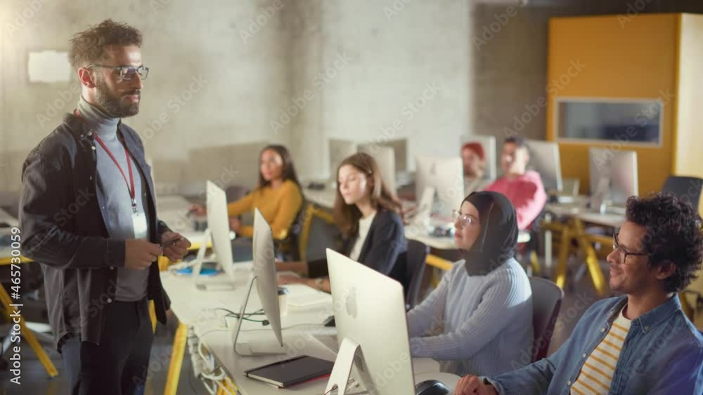 Teacher Giving Lesson to Diverse Multiethnic Group of Female and Male Students in College Room, Learning New Academic Skills on a Computer. Lecturer Shares Knowledge with Smart Young Scholars. Teacher Giving Lesson to Diverse Multiethnic Group of Female and Male Students in College Room, Learning New Academic Skills on a Computer. Lecturer Shares Knowledge with Smart Young Scholars.