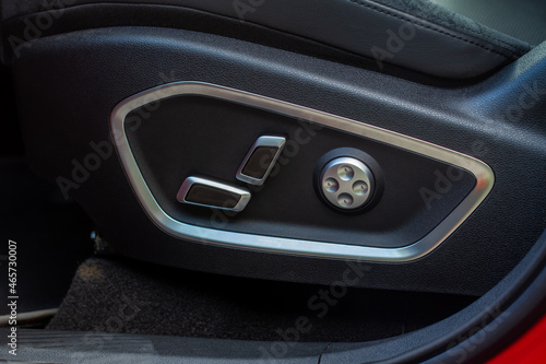 Electric car seat adjustment control panel close up view. Adjustable car seat position. Car interior. © Roman