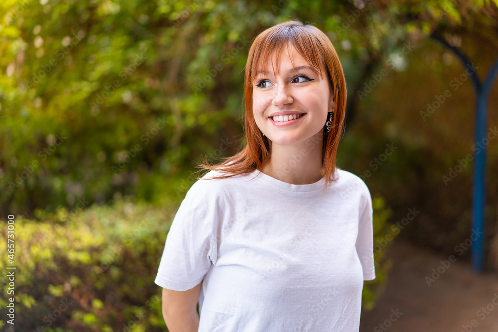 Young pretty redhead woman at outdoors . Portrait Young pretty redhead woman at outdoors . Portrait