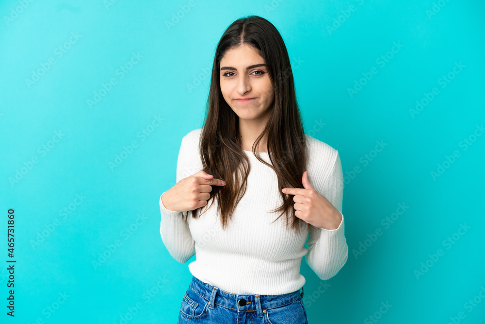 Young caucasian woman isolated on blue background pointing to oneself Young caucasian woman isolated on blue background pointing to oneself