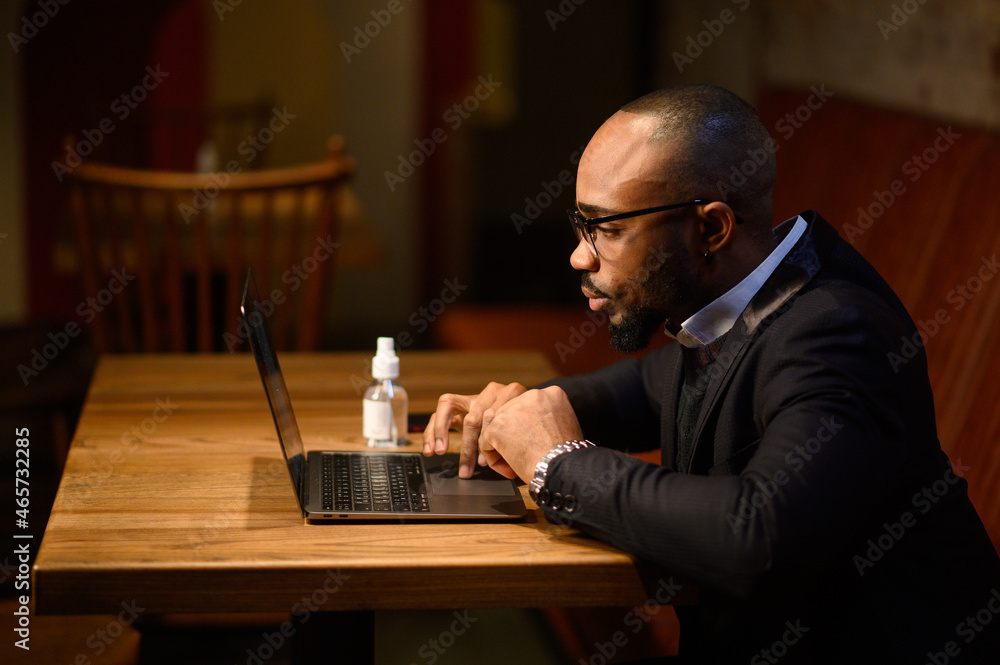 An African-American business man in a business suit is talking on a video conference. Video conference with partners