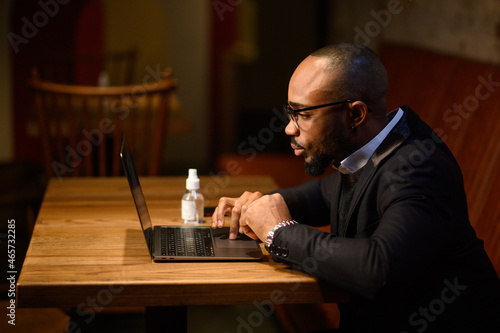 An African-American business man in a business suit is talking on a video conference. Video conference with partners