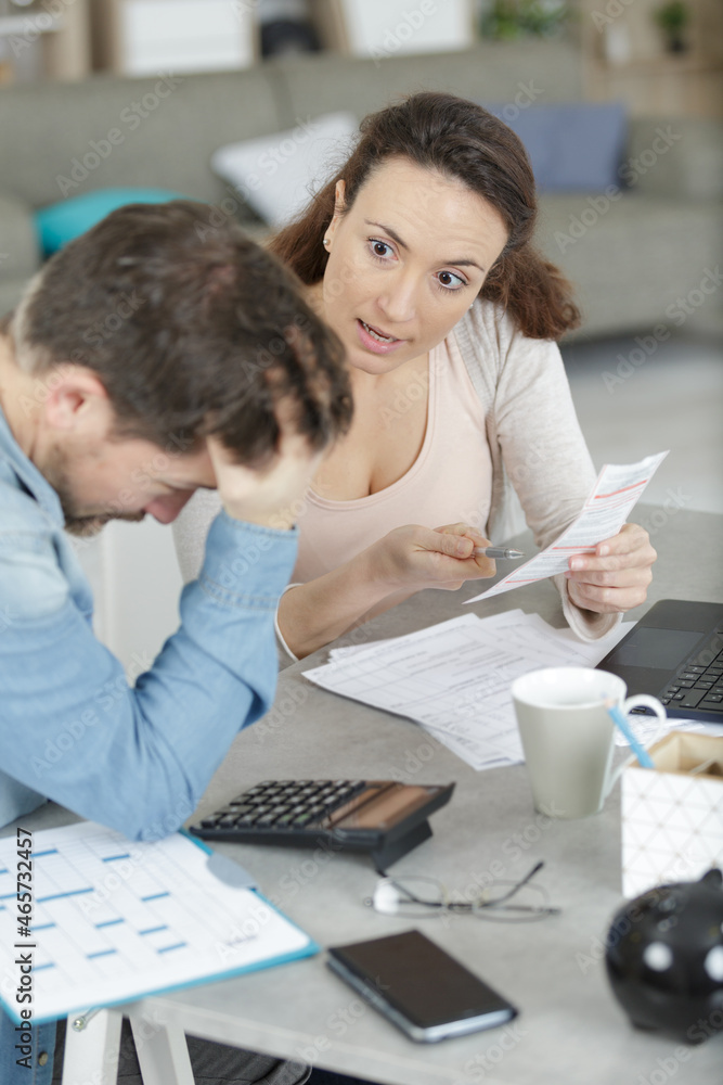 upset couple with financial bills having conflict at home upset couple with financial bills having conflict at home