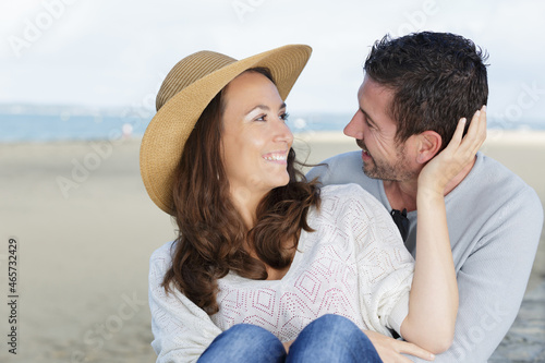 happy couple kissing on the beach