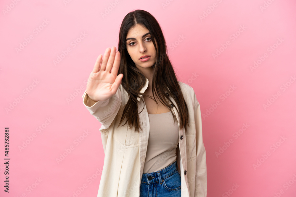 Young caucasian woman isolated on pink background making stop gesture Young caucasian woman isolated on pink background making stop gesture