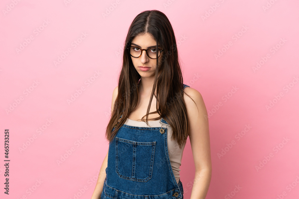 Young caucasian woman isolated on pink background with sad expression Young caucasian woman isolated on pink background with sad expression