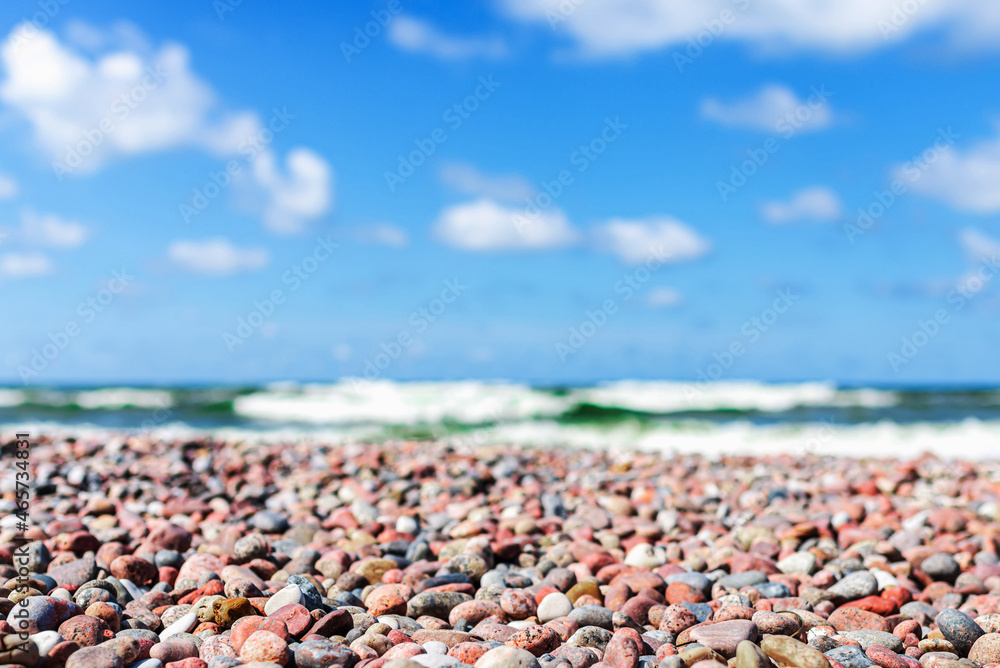 Small pebbles on the shore. sunny summer day blue sky,white clouds. beautiful lonely pebble beach.Copy space. Small pebbles on the shore. sunny summer day blue sky,white clouds. beautiful lonely pebble beach.Copy space.