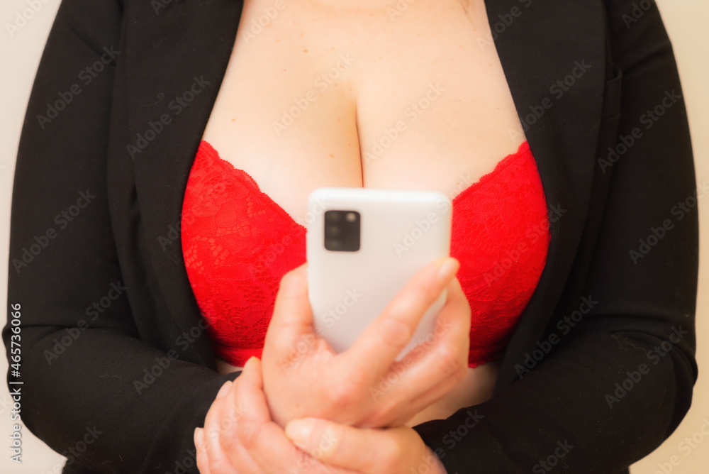 Busty big breasts secretary in red bra online flirt on the phone, desire.Sexy Flirt online concept. Busty big breasts secretary in red bra online flirt on the phone, desire.Sexy Flirt online concept.