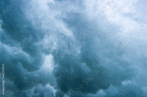 Underwater View of Wave Crashing to Shore Spraying Drops of Water Across the Sea