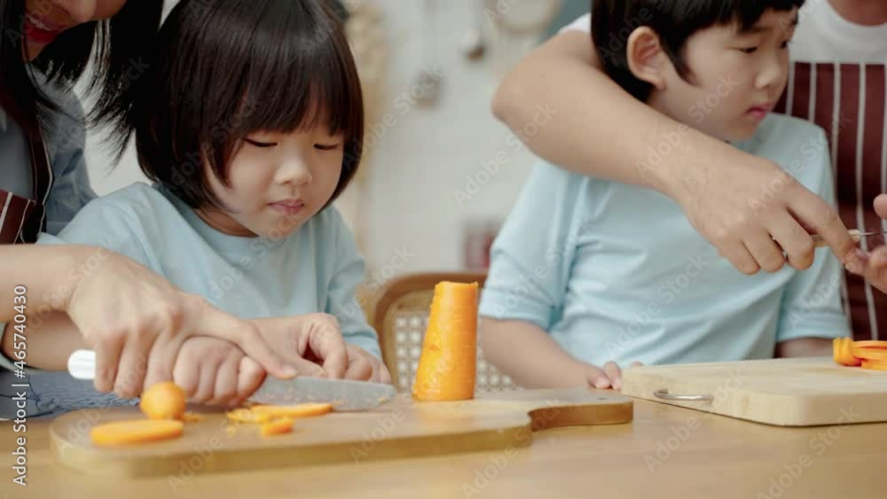 Asian happy family doing activities together in the living room. Father and mother brought paper to make a roof for the children to run around.Family relationship
Asian happy family doing activities together in the living room. Father and mother brought paper to make a roof for the children to run around.Family relationship